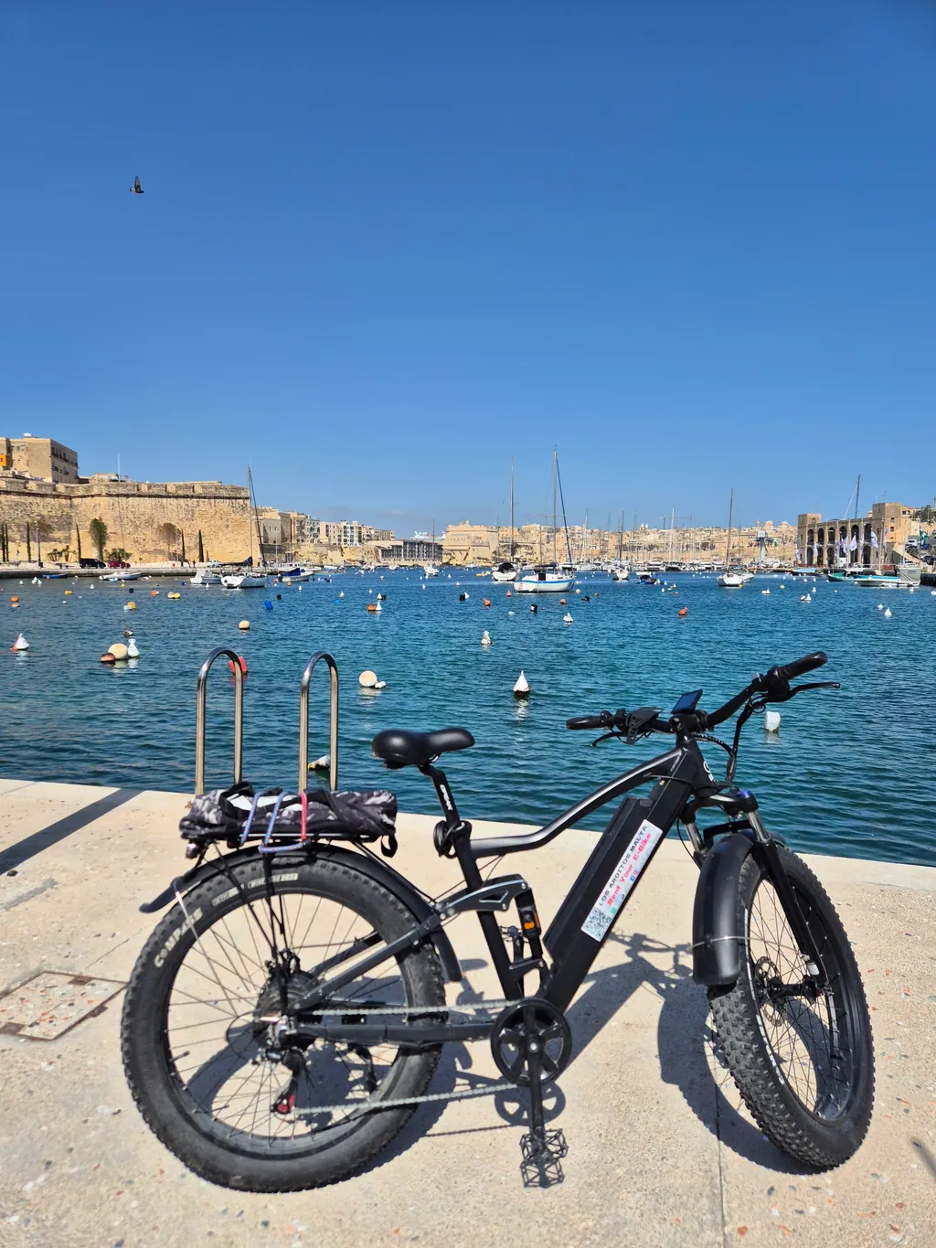 E-bike parked on the Grand Harbour waterfront facing Birgu and Senglea